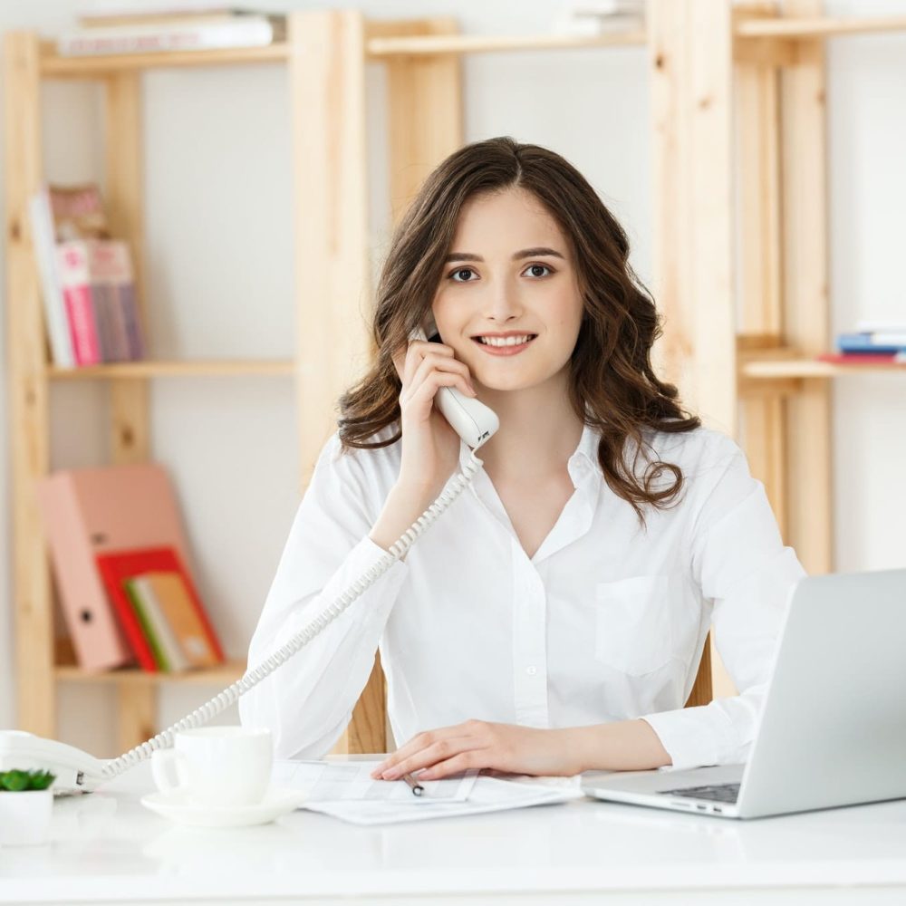 young-woman-talking-on-phone-in-modern-office.jpg